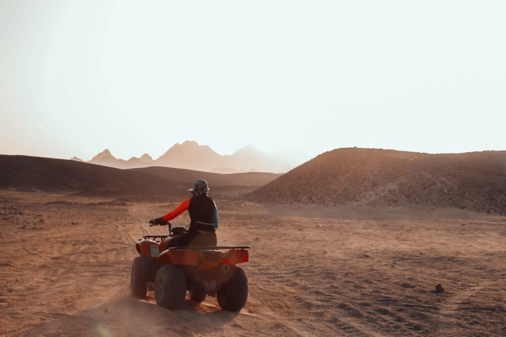 Girl rides an ATV in the desert